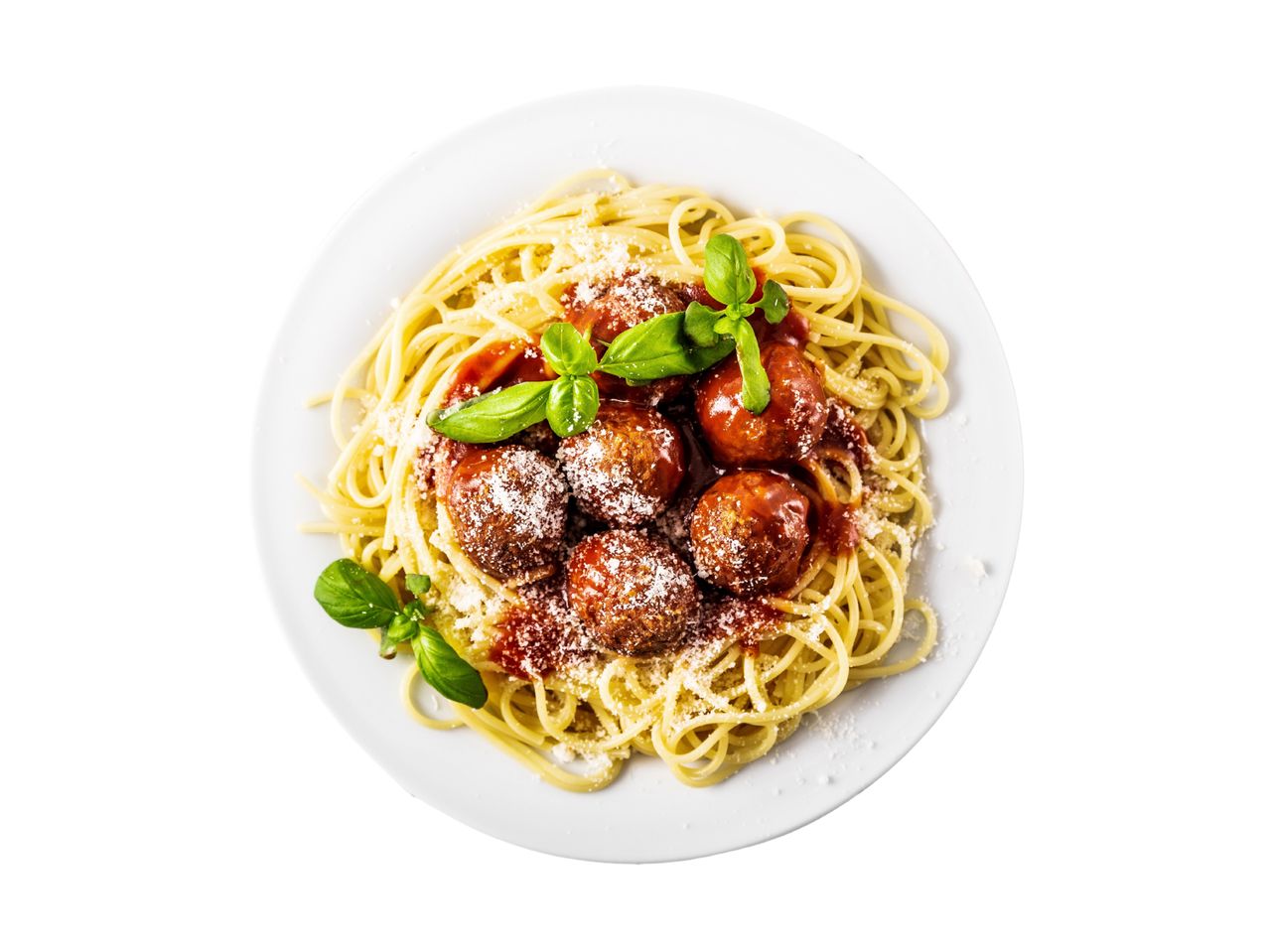Spaghetti and meatballs with tomato sauce, parmesan cheese, and fresh basil on a white plate.