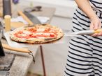 Margherita pizza on a pizza peel.