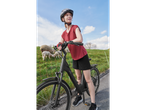 Woman on an e-bike in a rural setting.