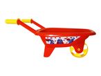 Red toy wheelbarrow with yellow handles and a Superman sticker on the side.