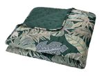 Folded green quilt with a tropical leaf pattern and a solid green underside.