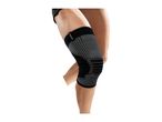 Close-up of a person's leg wearing a black and grey knee support brace.