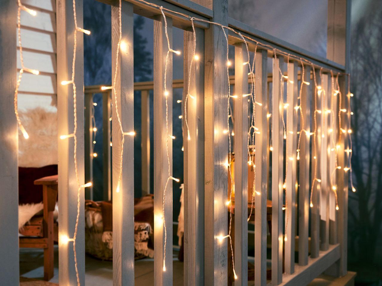 Fairy lights draped over a wooden railing, creating a cozy atmosphere.