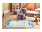 A child drawing on a water doodle mat with a plush toy nearby.