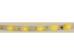 Close-up of an illuminated LED strip with color-changing LEDs and integrated circuitry.
