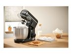 Black SilverCrest stand mixer with a stainless steel bowl, ingredients on a wooden table.