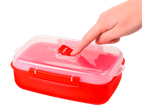 Hand pressing the red Sistema lunchbox lid with a transparent top.