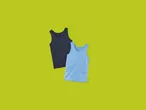 Two Lupilu® Kids' Vests, one dark blue and one light blue, on a green background.
