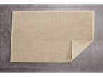 LIVARNO home Bath Mat, beige, textured, on a gray tiled floor with one corner folded.