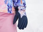 Child's floral ski jacket and pink ski pants with navy gloves