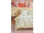 Bedroom with lemon-patterned Livarno Jersey Fitted Sheet, striped duvet, and pink accents.