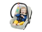 Happy baby in a car seat with colorful toy rings hanging from the handle.