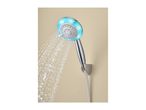 Handheld shower head with blue LED lights and water spraying out