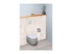 Wall-mounted toilet with a flush plate, toilet paper holder, and a wooden shelf with decor.