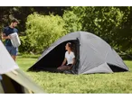 Man in CRIVIT sports top holding a sleeping bag, woman in a tent.