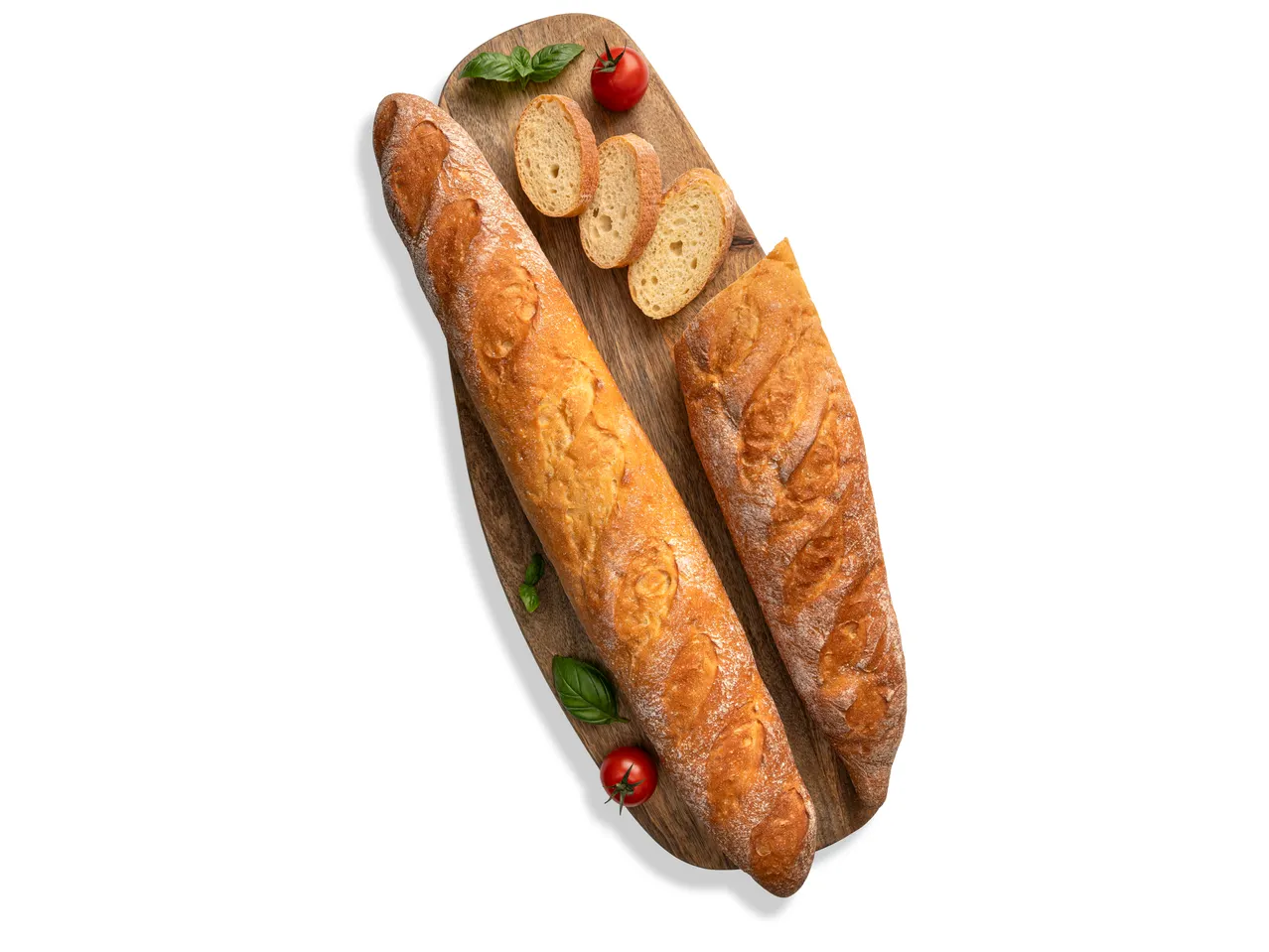 Két durum baguette, egy felszeletelve, bazsalikommal és koktélparadicsommal egy vágódeszkán.